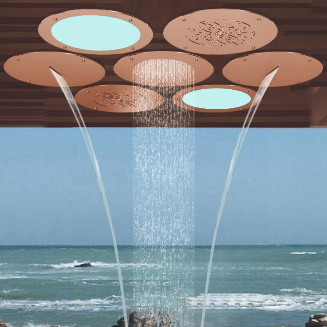 Smart ceiling shower system with chroma lighting, integrated speakers, cascading water flow, mist function, and centralized drain tile for luxury bathrooms.